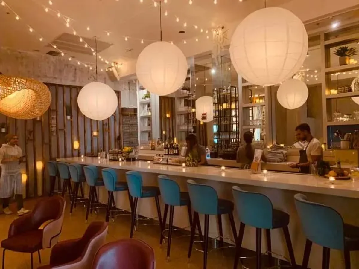 The bar with paper lanterns and blue stools